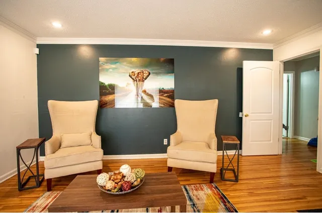 a living room with furniture and wooden floor