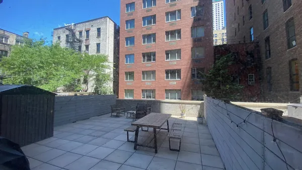 a backyard of a house with table and chairs
