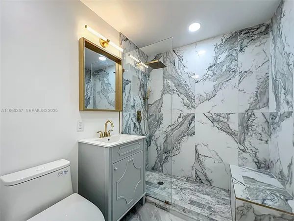 a bathroom with a sink toilet and shower
