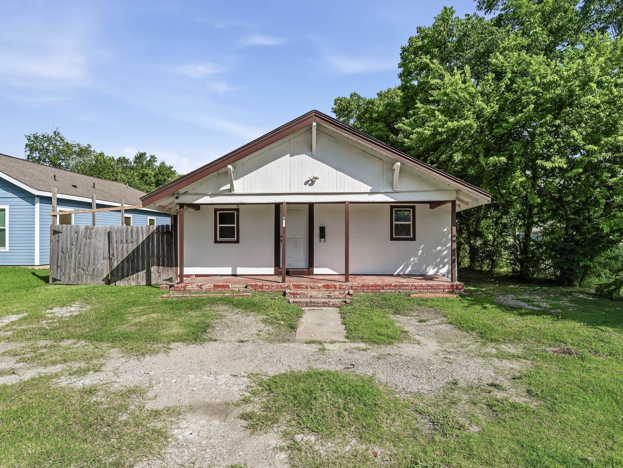 737 9th Street Port Arthur, TX 77640 - Photo 1 of 20 a front view of a house with a garden and porch