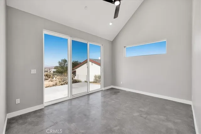 an empty room with sliding glass door