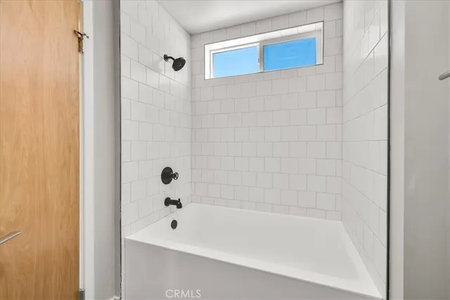 an empty room with windows and stairs