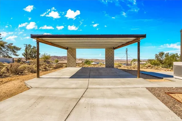 a view of a house with a yard covered with snow in front of it