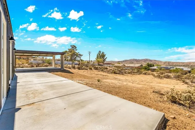 a view of a house with snow on the road