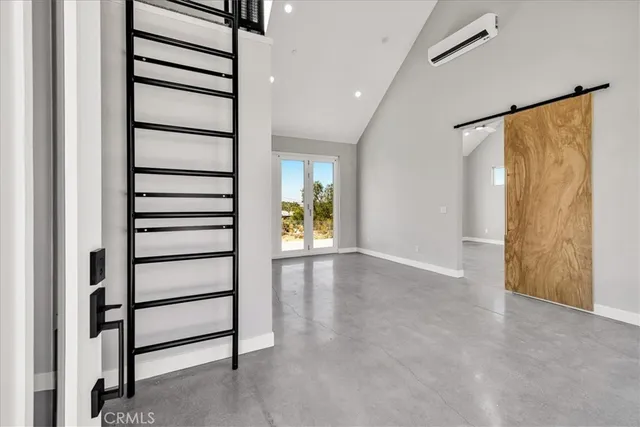 a view of a hallway with wooden floor and windows with curtains