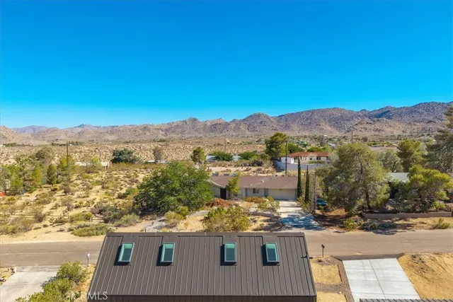 an aerial view of residential houses with ocean view