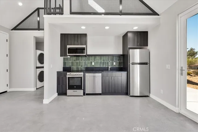 a kitchen with stainless steel appliances kitchen island granite countertop a refrigerator and a stove