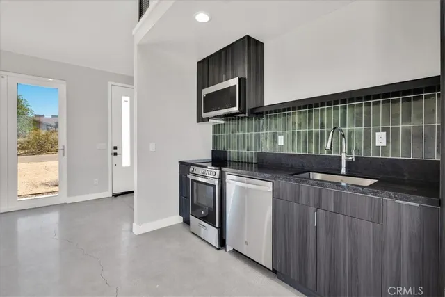 a kitchen with stainless steel appliances a stove and a microwave