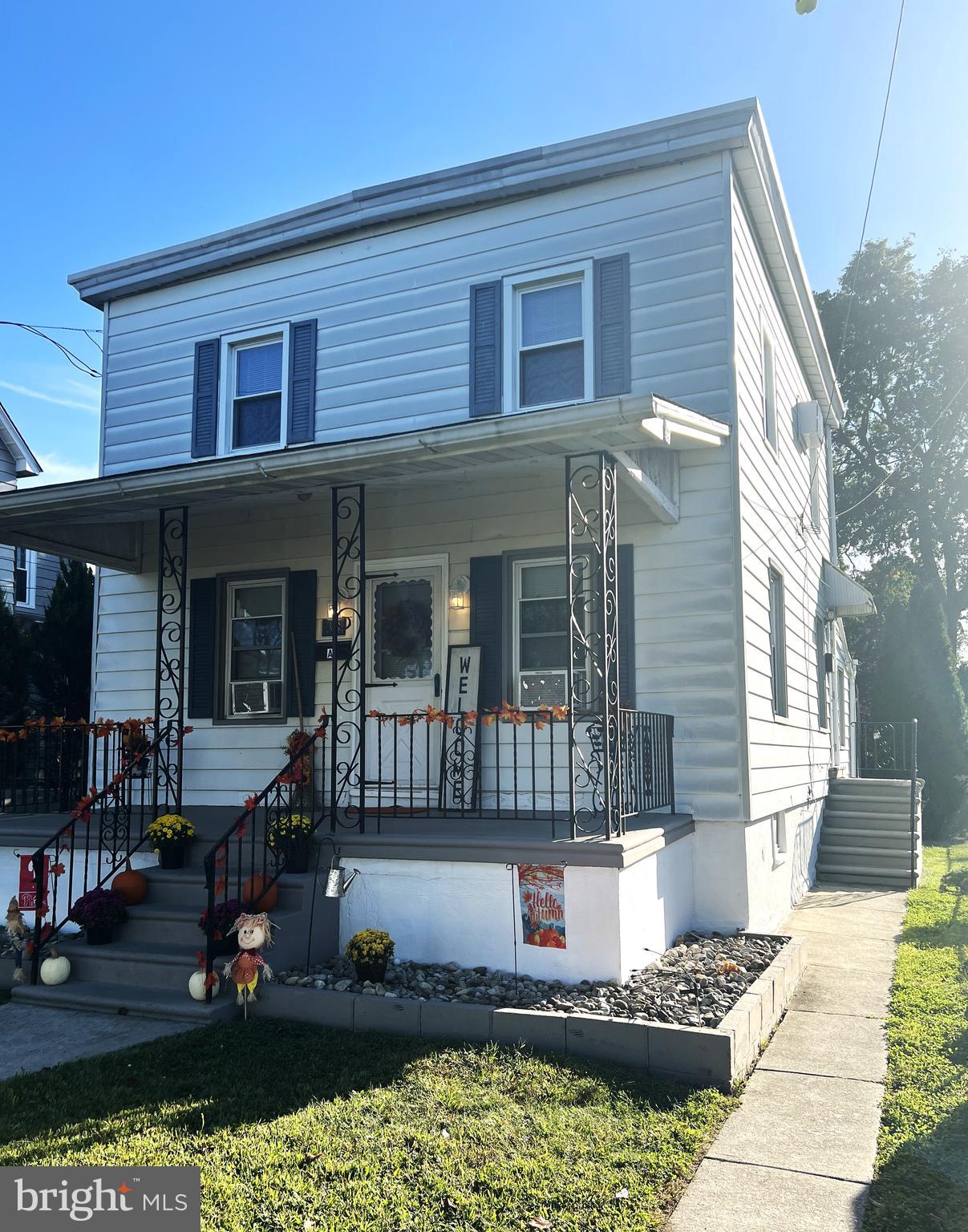 a front view of a house with lots of potted plants