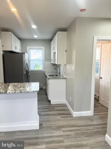 a kitchen with stainless steel appliances granite countertop a refrigerator and a stove