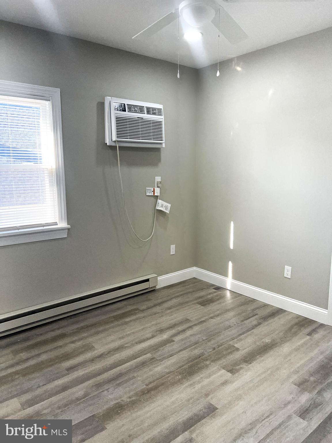30 Spruce Avenue, Unit B Maple Shade, NJ 08052 - Photo 5 of 23 an empty room with wooden floor and windows