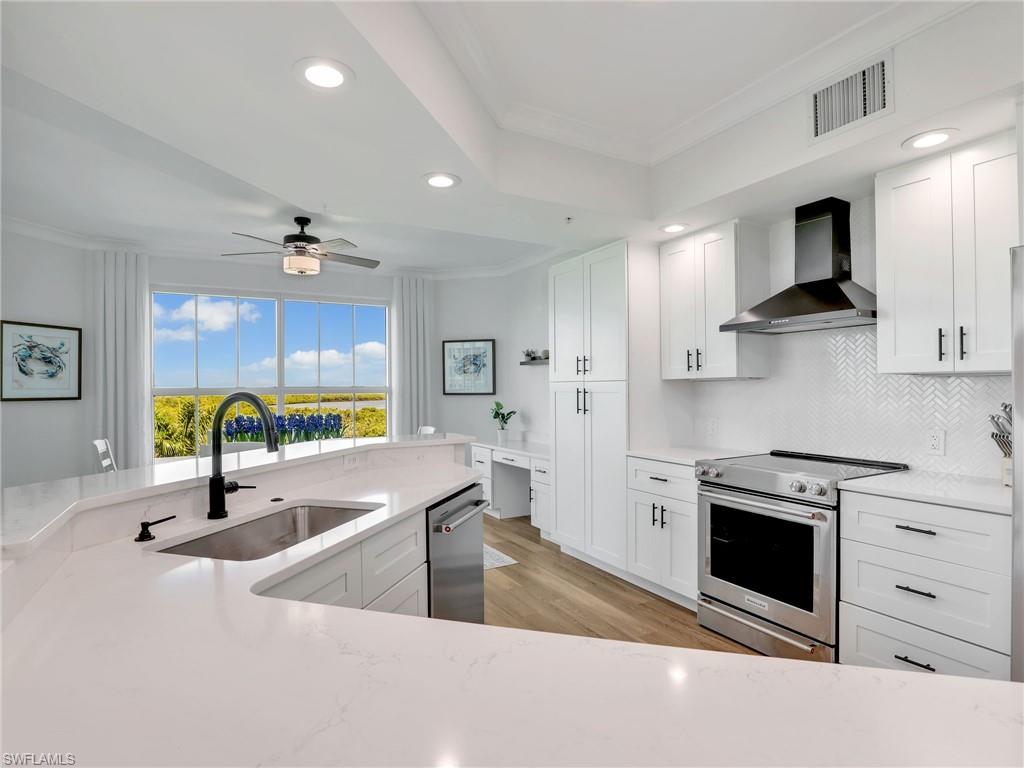 325 Dunes Boulevard, Unit 403 Naples, FL 34110 - Photo 15 of 49 a kitchen with stainless steel appliances granite countertop a sink a stove and a refrigerator