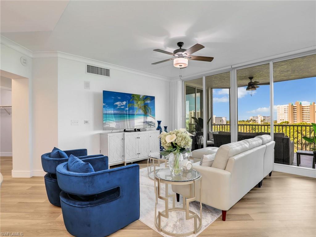 325 Dunes Boulevard, Unit 403 Naples, FL 34110 - Photo 16 of 49 a living room with furniture and a large window