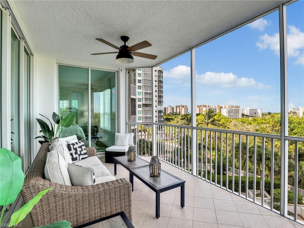 325 Dunes Boulevard, Unit 403 Naples, FL 34110 - Photo 20 of 49 a living room with furniture and a floor to ceiling window