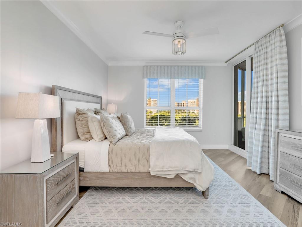 325 Dunes Boulevard, Unit 403 Naples, FL 34110 - Photo 24 of 49 a bedroom with a bed and a night stand