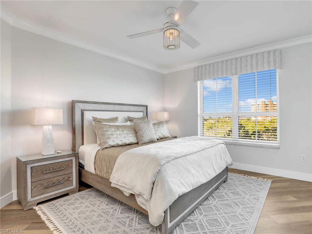 325 Dunes Boulevard, Unit 403 Naples, FL 34110 - Photo 25 of 49 a bedroom with a large bed and a window