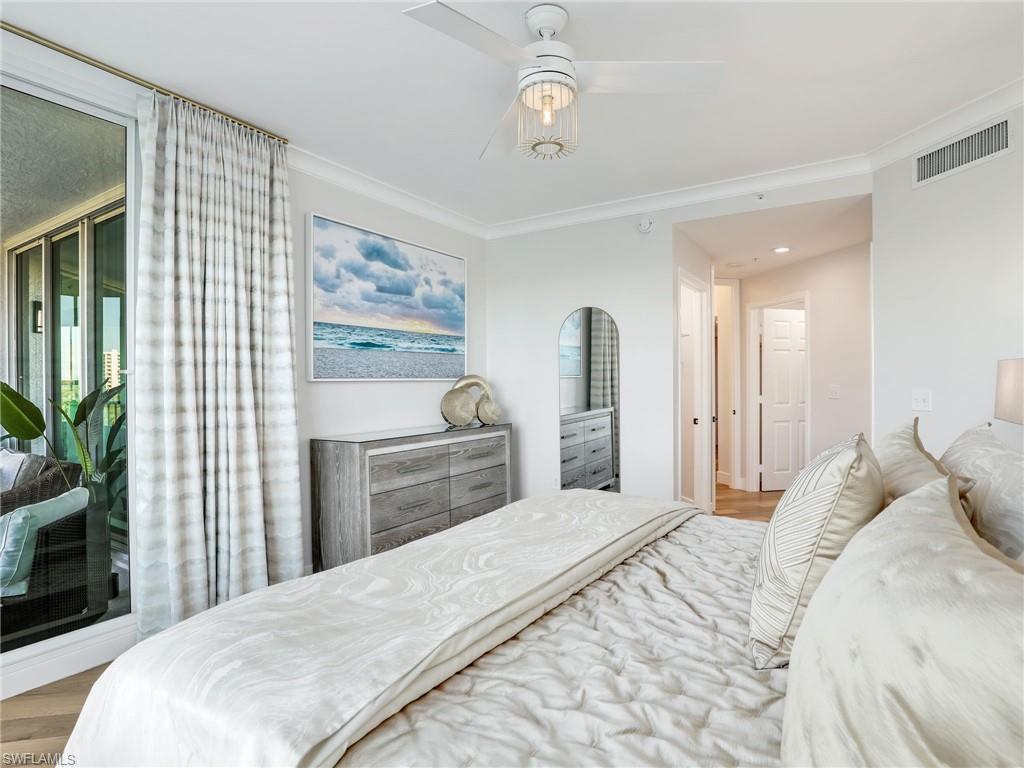 325 Dunes Boulevard, Unit 403 Naples, FL 34110 - Photo 26 of 49 a bedroom with a bed and a television
