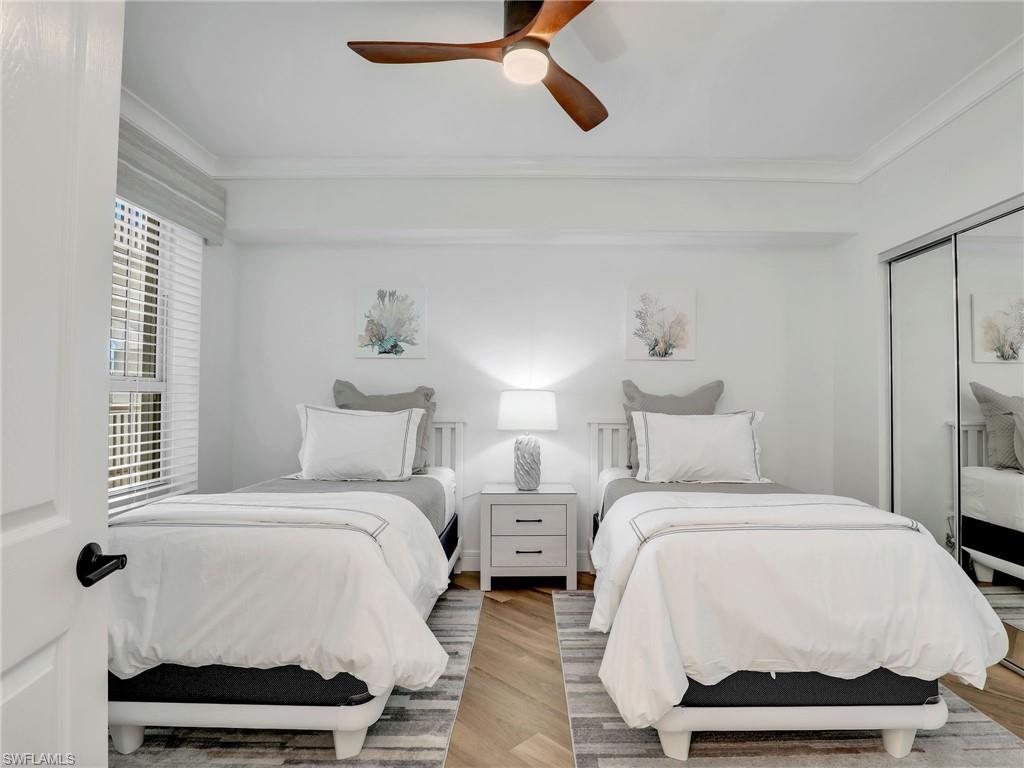 325 Dunes Boulevard, Unit 403 Naples, FL 34110 - Photo 32 of 49 a bedroom with a bed and a window