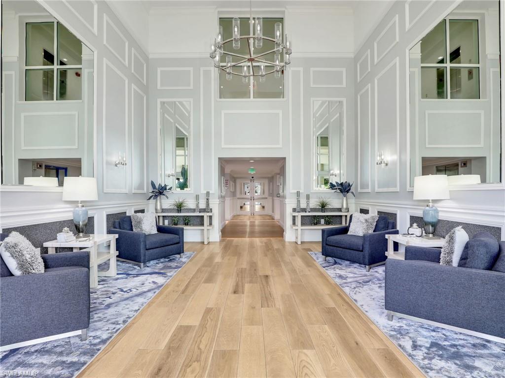 325 Dunes Boulevard, Unit 403 Naples, FL 34110 - Photo 4 of 49 a living room with furniture and a fireplace