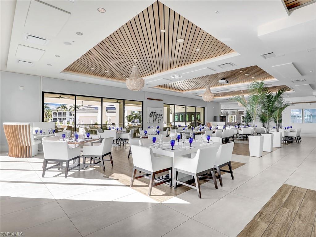 325 Dunes Boulevard, Unit 403 Naples, FL 34110 - Photo 42 of 49 a view of a dining room with furniture