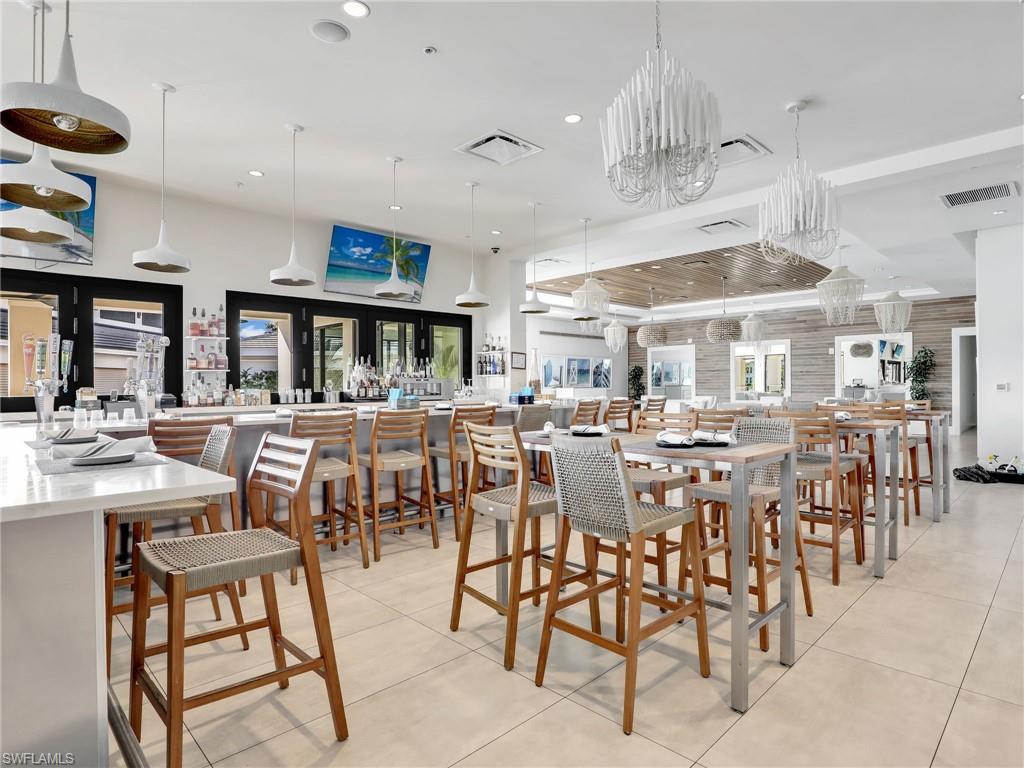 325 Dunes Boulevard, Unit 403 Naples, FL 34110 - Photo 43 of 49 a dining hall with lots of tables and chairs