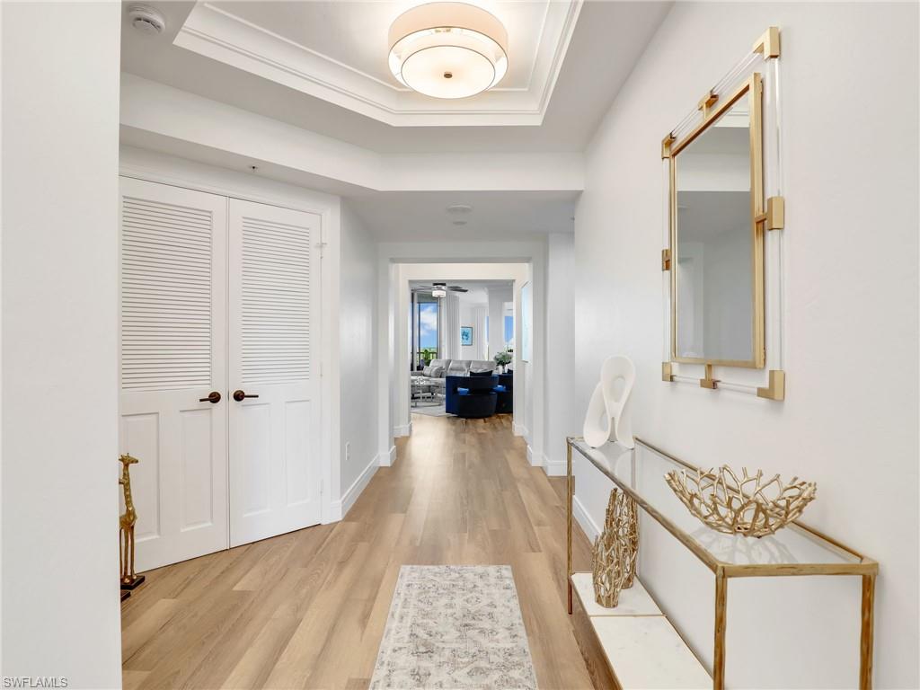 325 Dunes Boulevard, Unit 403 Naples, FL 34110 - Photo 6 of 49 a view of a hallway view with wooden floor and staircase