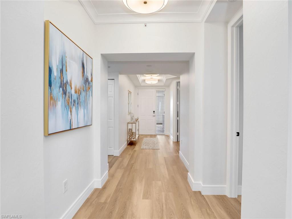 325 Dunes Boulevard, Unit 403 Naples, FL 34110 - Photo 7 of 49 a view of a hallway with wooden floor and closet