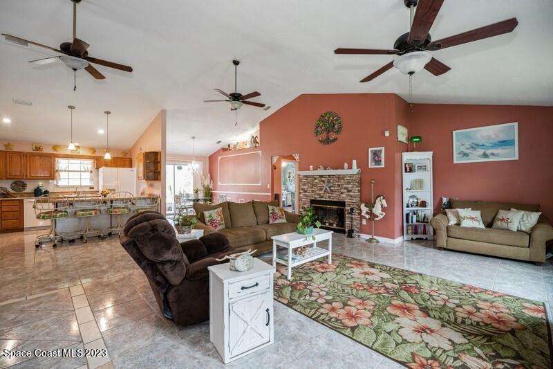 5337 Bridge Road Cocoa, FL 32927 - Photo 8 of 28 a living room with furniture and a fireplace