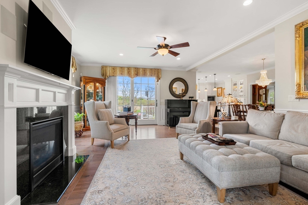4 Point Shore Overlook Amesbury, MA 01913 - Photo 11 of 42 a living room with furniture a flat screen tv and a fireplace