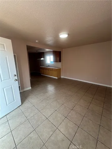 a view of an empty room with a fireplace