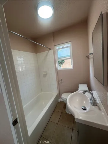 a bathroom with a sink a mirror and a bathtub