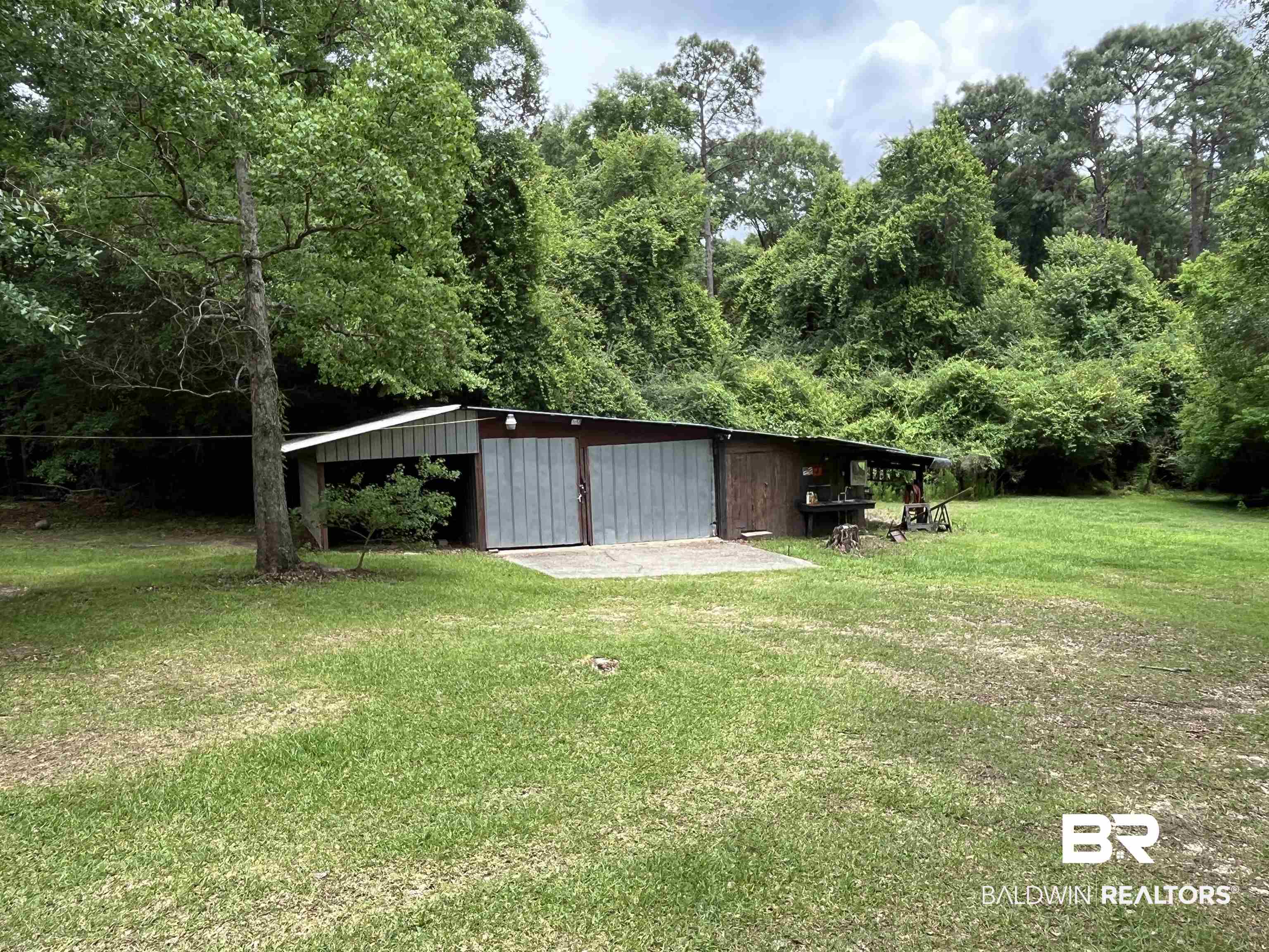 1905 Rockaway Creek Road Atmore, AL 36502 - Photo 6 of 23 Detached outbuilding featuring multiple bay doors and an extended covered patio