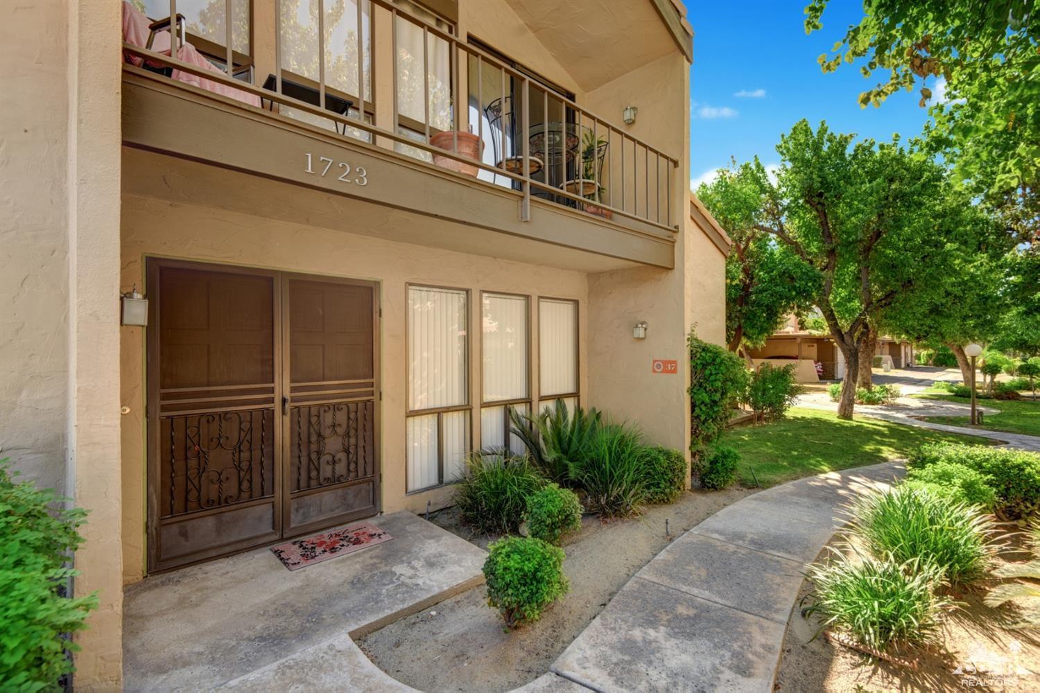 1723 Ramon Road, Unit 37 Palm Springs, CA 92264 - Photo 1 of 10 a view of a house with a small yard plants and large tree