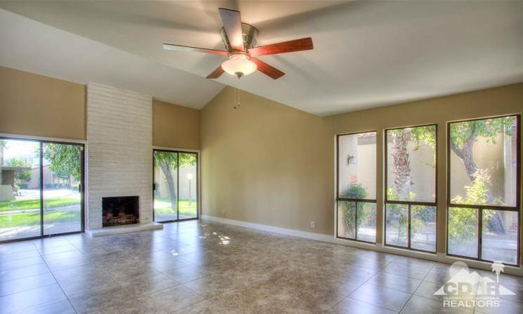 1723 Ramon Road, Unit 37 Palm Springs, CA 92264 - Photo 3 of 10 a view of an empty room with wooden floor and a window