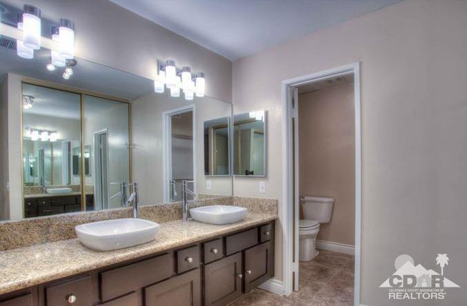1723 Ramon Road, Unit 37 Palm Springs, CA 92264 - Photo 5 of 10 a bathroom with a granite countertop sink a toilet and a mirror