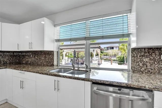 an empty room with fan and windows