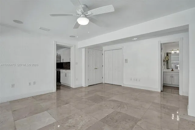 a kitchen with granite countertop a refrigerator and a sink