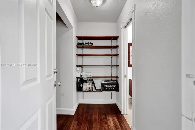 a view of a house with backyard and a tree