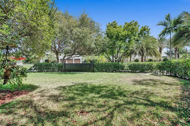 an aerial view of a city with lots of residential buildings ocean and mountain view in back