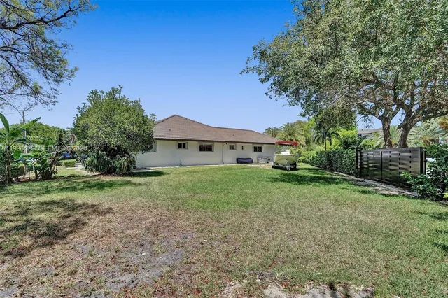 a aerial view of a house with a yard and patio