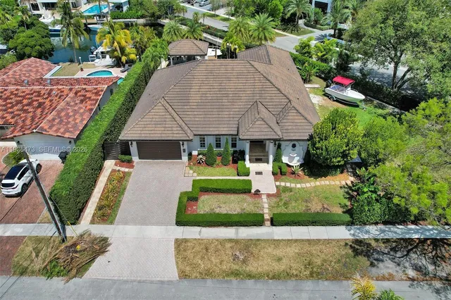 a front view of a house with a garden and plants