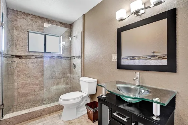 a view of a patio with couches table and chairs and potted plants