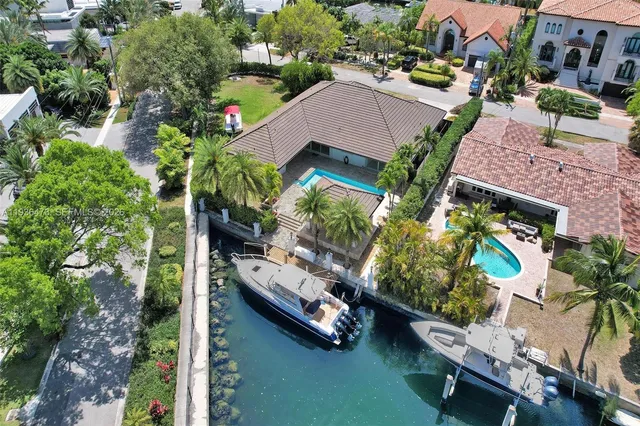 a view of a patio with table and chairs with a barbeque grill and couches