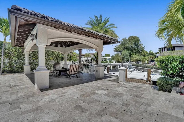a view of a patio with a table and chairs under an umbrella