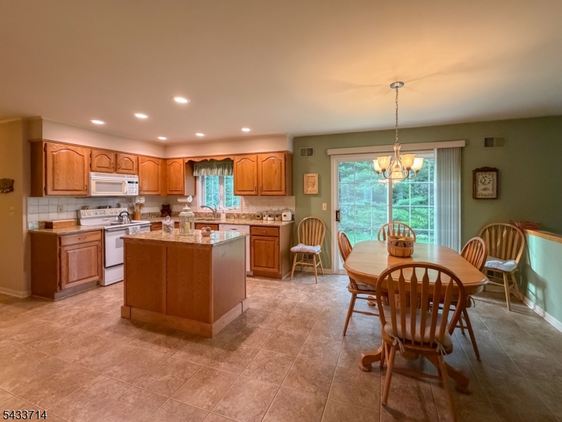 29 Lark Lane Oak Ridge, NJ 07438 - Photo 3 of 26 a kitchen with a table chairs a dining table and chairs