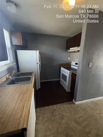 a kitchen with a refrigerator and a stove