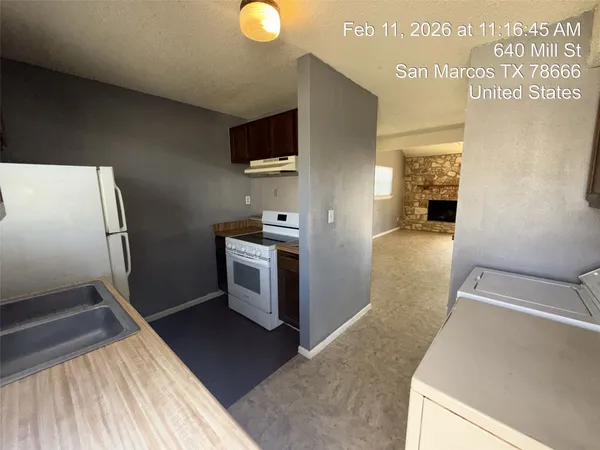 a view of a kitchen from the hallway