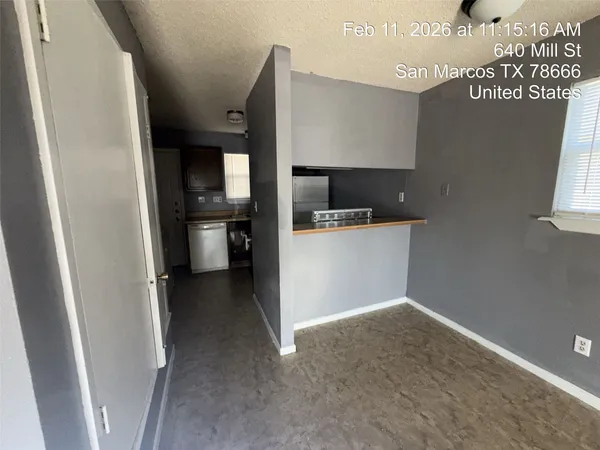 a kitchen with a refrigerator and a sink