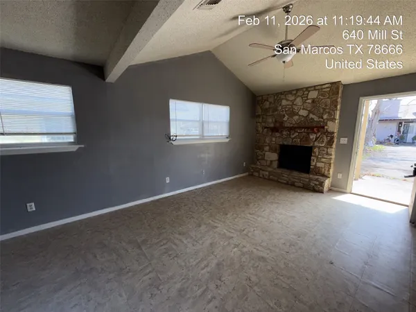a view of an empty room with a fireplace