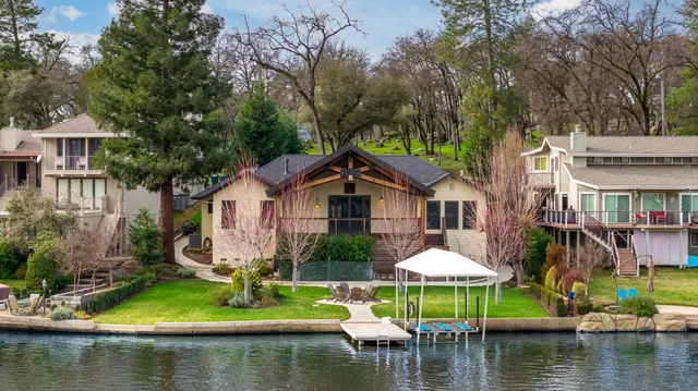 a front view of a house with a yard and swimming pool